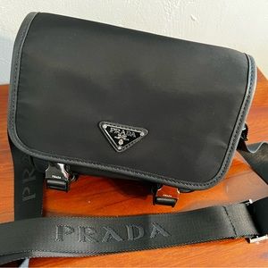 Black shoulder or crossbody Prada bag.